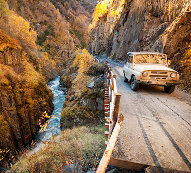Soviet SUV UAZ in the Caucasus mountains on a mountain road